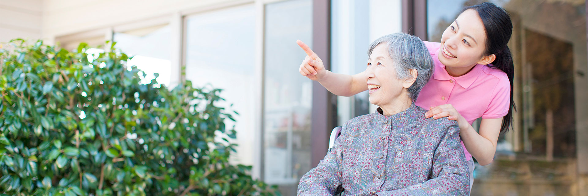 Happy woman outside of nursing home with relative