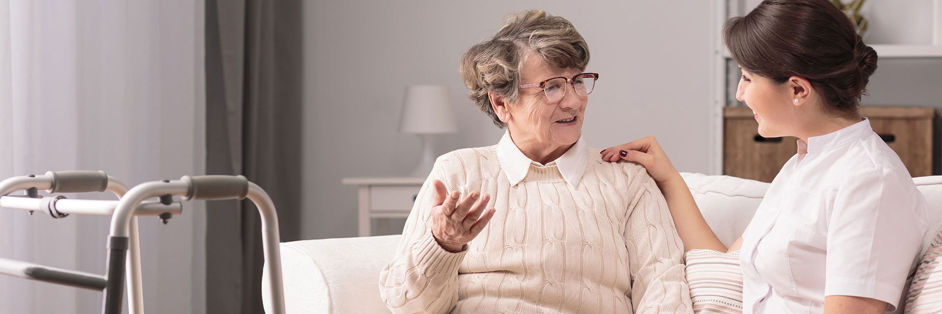 Happy older woman in nursing home with nurse